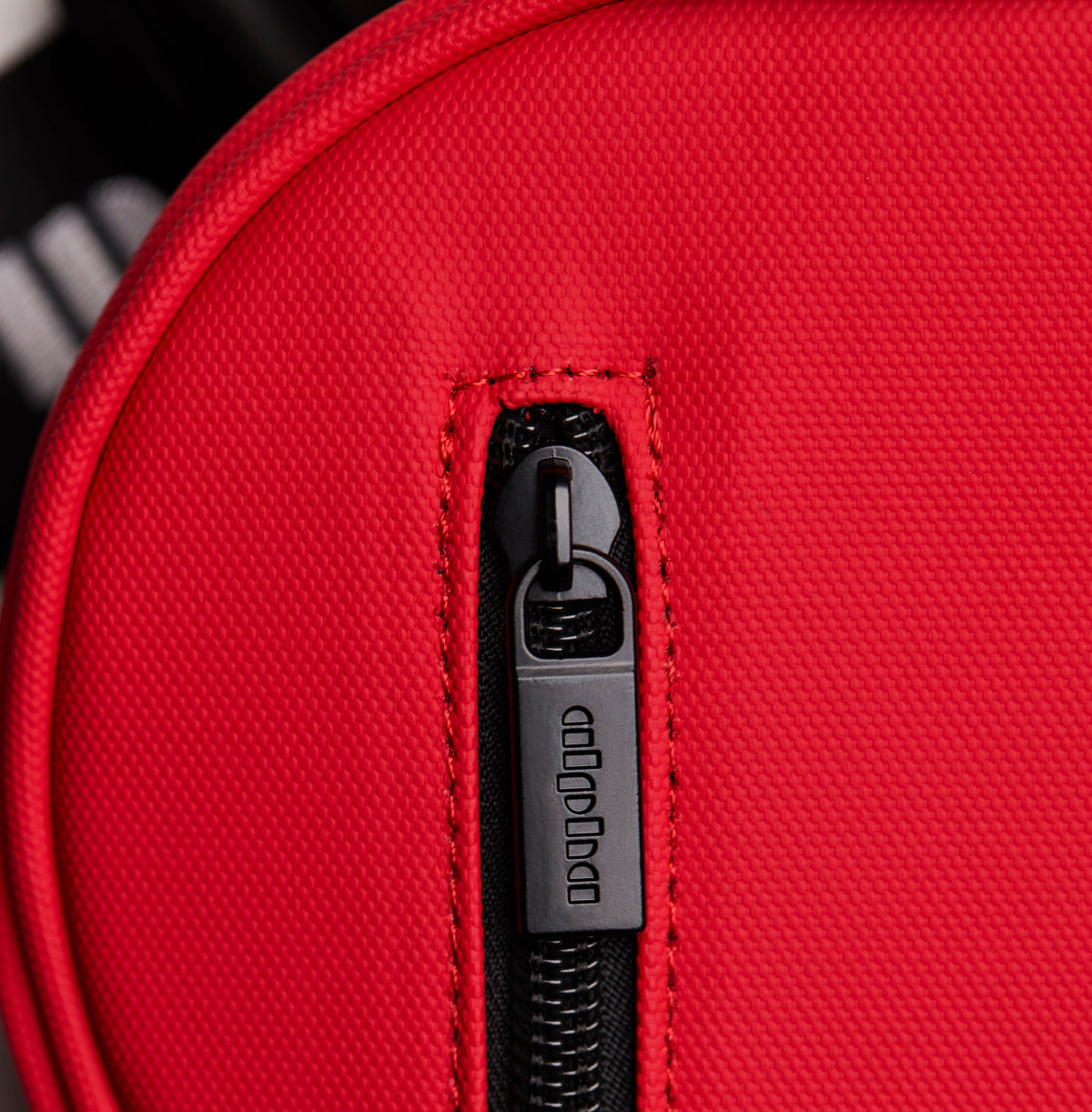Red bag with a black zipper and 'Alpha' brand logo.